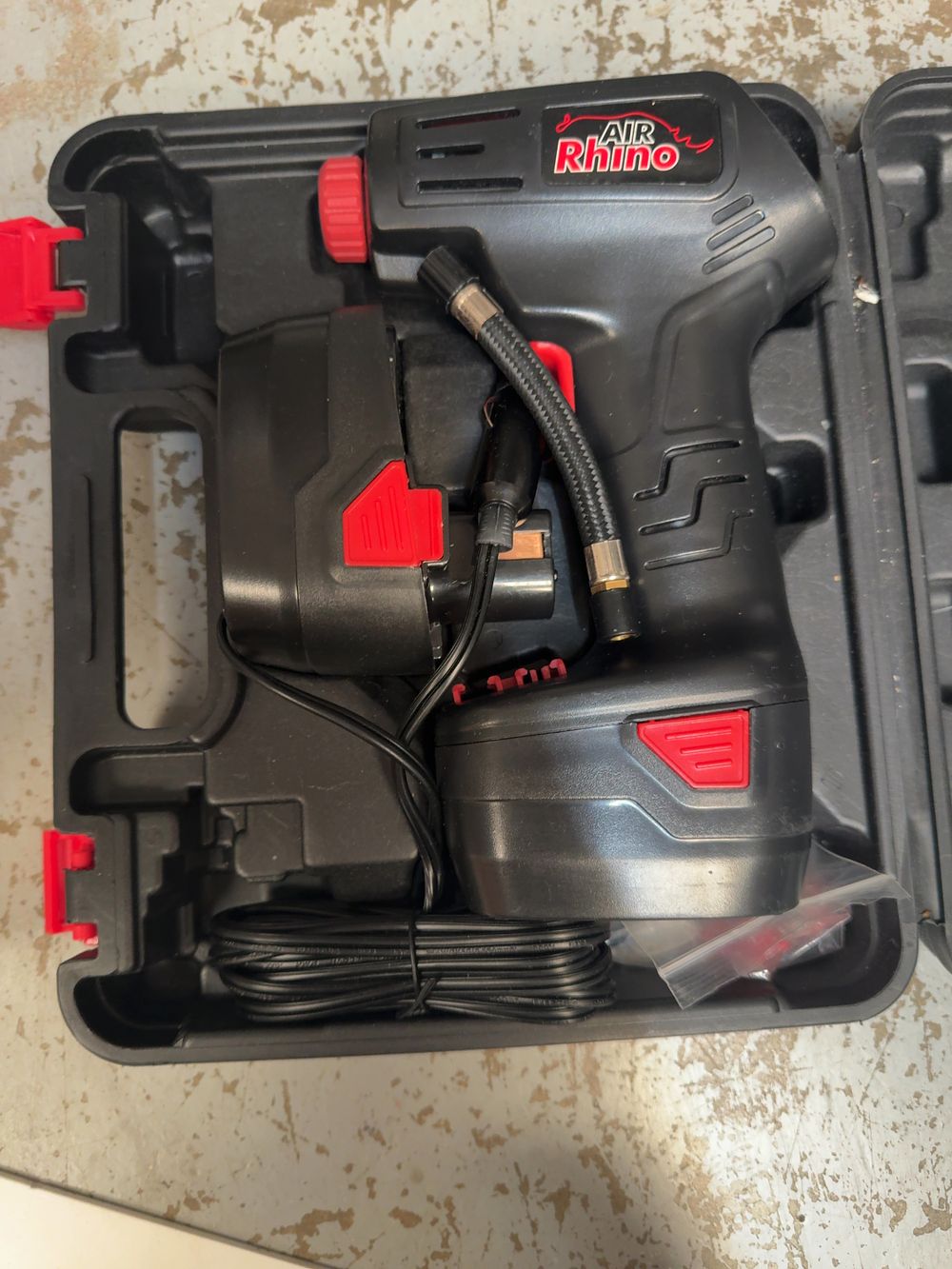 Lot 233: An Air Rhino Portable Cordless Air Compressor Kit with Accessories in Case