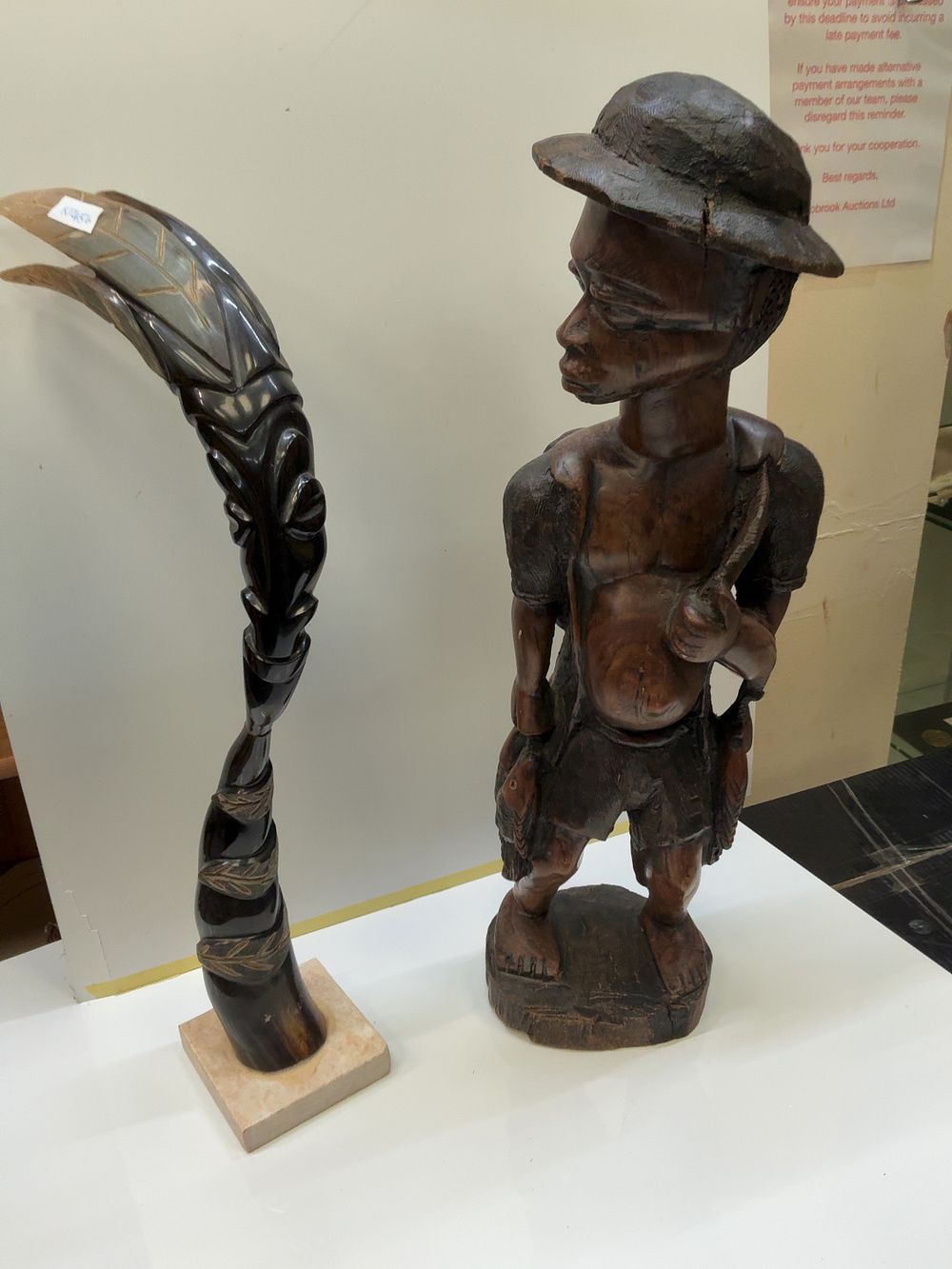 Lot 244: Two East African style Carved Sculptures Including a Wooden Fisherman and a Signed Horn Figure