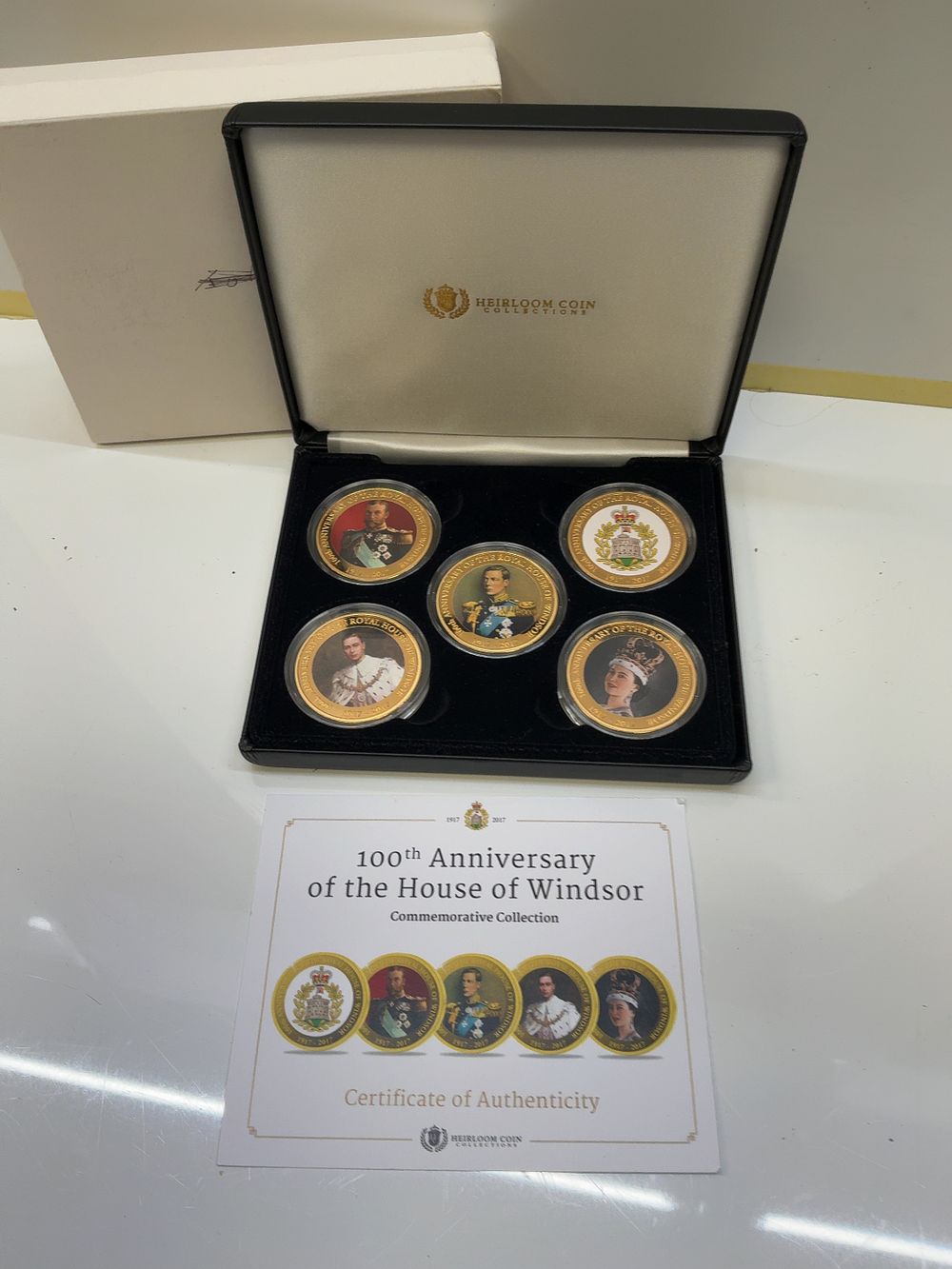 Lot 251: A Set of Five Heirloom Coin Collections House of Windsor 100th Anniversary Gold-Toned Medals with Presentation Case