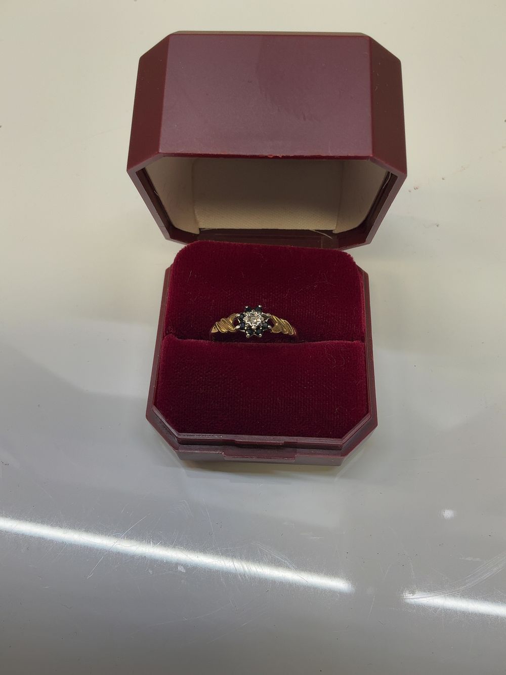 Lot 252: A 9ct Yellow Gold Sapphire and Diamond Cluster Ring