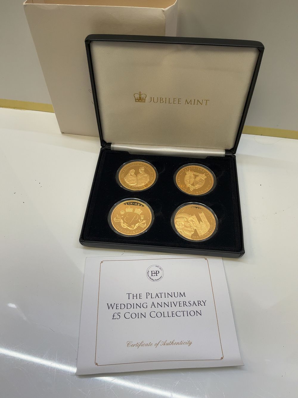 Lot 253: A Set of Four 2017 Platinum Wedding Anniversary Jubilee Mint Gold-Plated Copper £5 Coins in Presentation Case