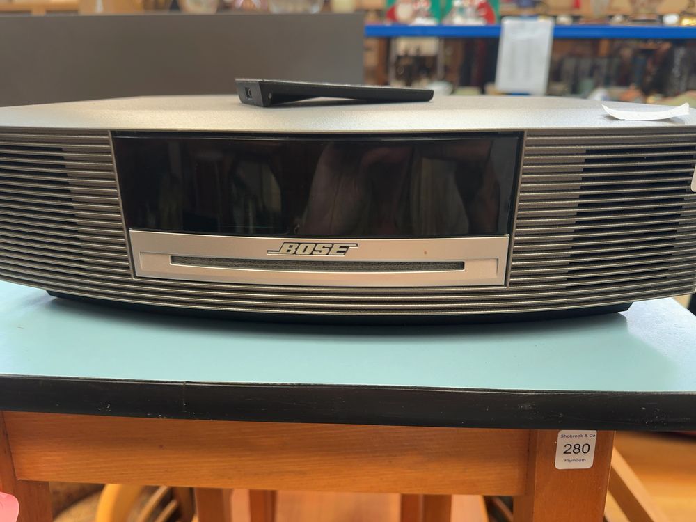 Lot 279: A Metallic Silver-Grey Bose Wave Music System III including Remote and Manual