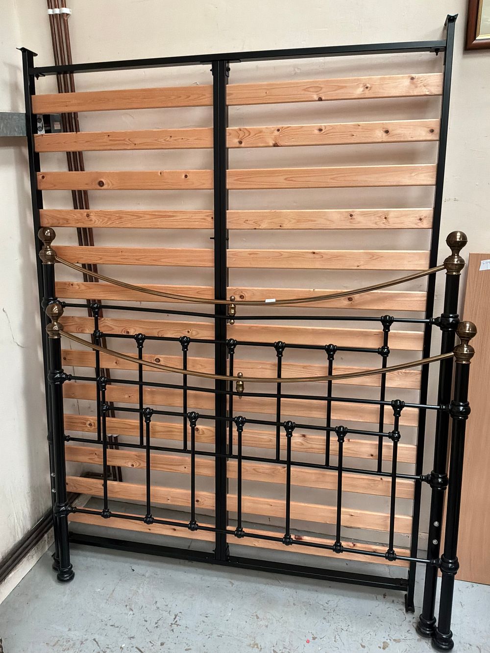 Lot 342: A Victorian Style Black Painted Iron and Brass Double Bedstead with Wooden Slatted Base