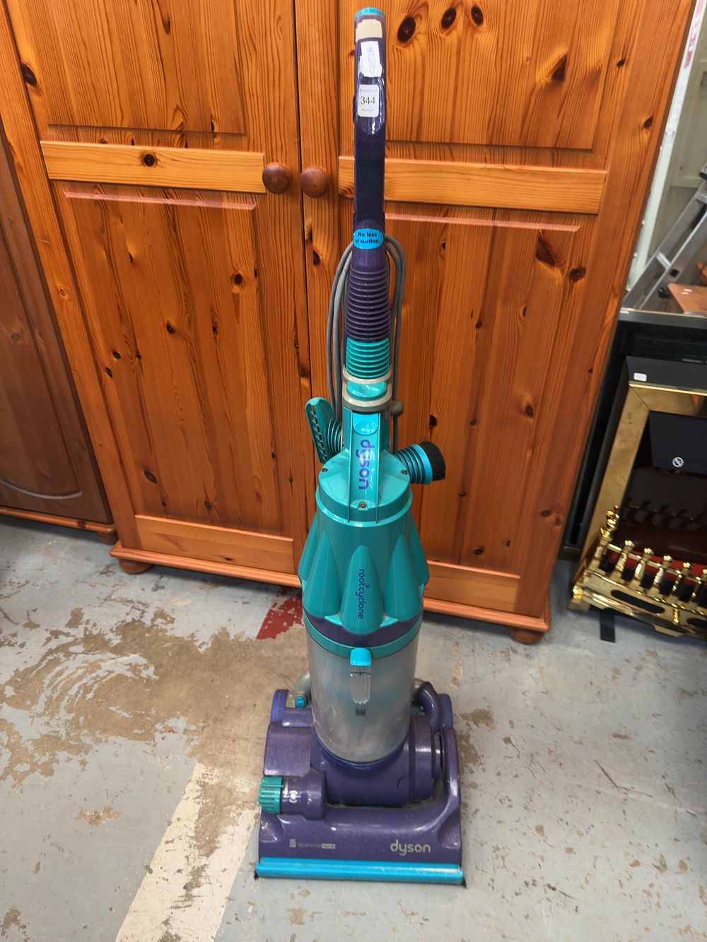 Lot 344: A Dyson DC07 Brush Control HEPA Upright Vacuum Cleaner in Purple and Teal