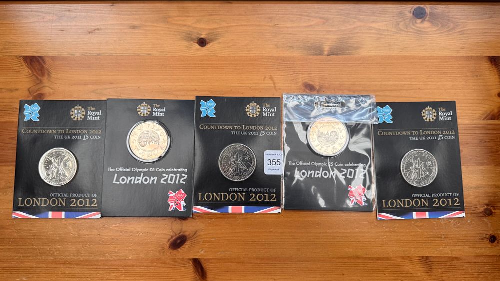 Lot 355: A Collection of Five London 2012 Olympic Commemorative The Royal Mint Cupro-Nickel £5 Coins in Presentation Folders