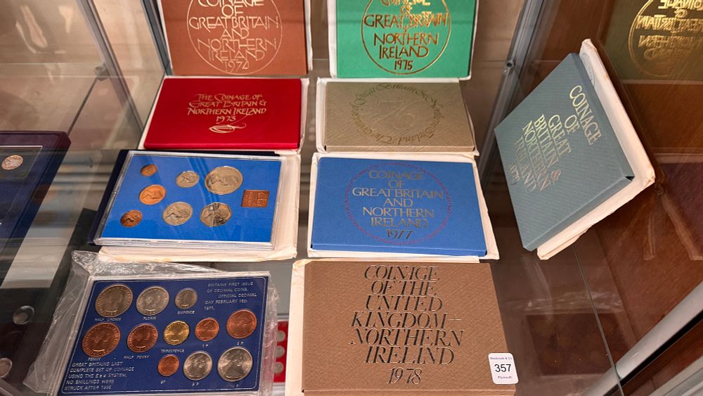 Lot 357: A Collection of Thirteen UK Royal Mint Base Metal Proof and Commemorative Coin Sets in Cases