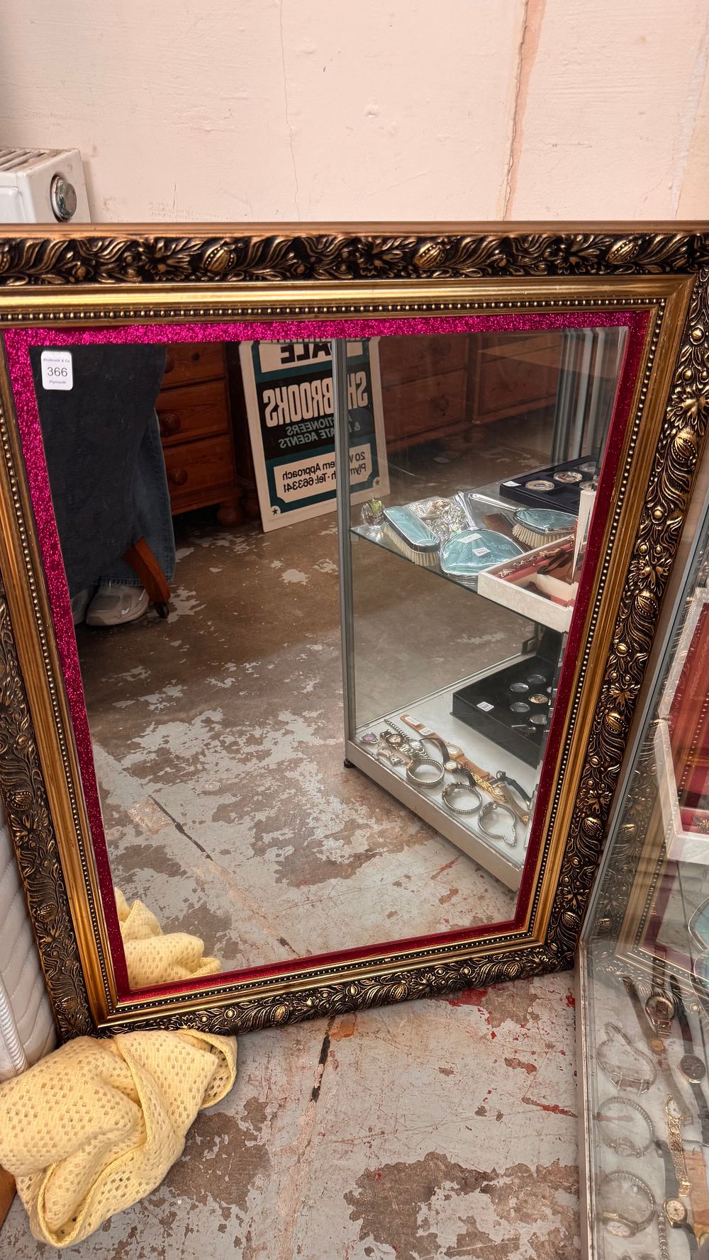 Lot 366: An Ornate Rococo style Gilt Finished Composite Wall Mirror with Magenta Glitter Inset