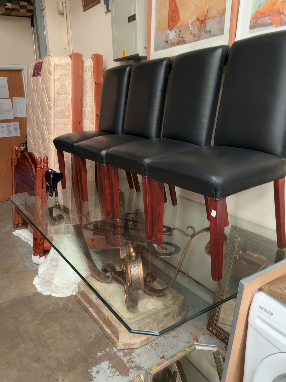 Lot 396: A Set of Eight Contemporary Faux Leather Dining Chairs and a Glass Topped Pedestal Dining Table