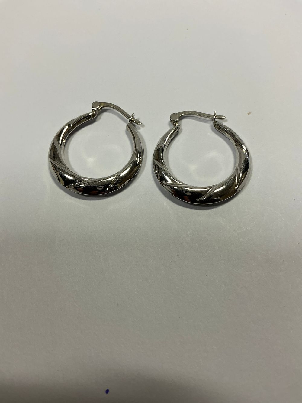 Lot 126: A Pair of Nine Carat White Gold Twisted Hoop Earrings