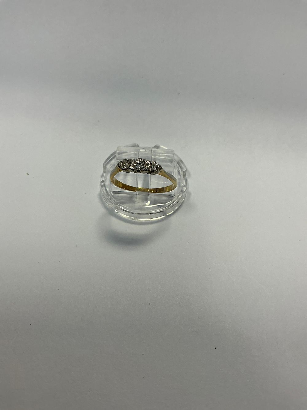 Lot 129: An 18 Carat Yellow Gold and White Metal Three Stone Diamond style Trilogy Ring