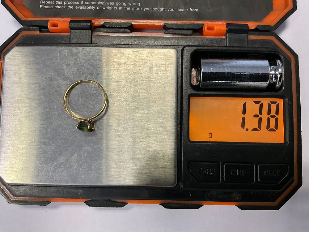 Lot 137: A Yellow Metal Ring Set With A Rectangular Step Cut Green Gemstone