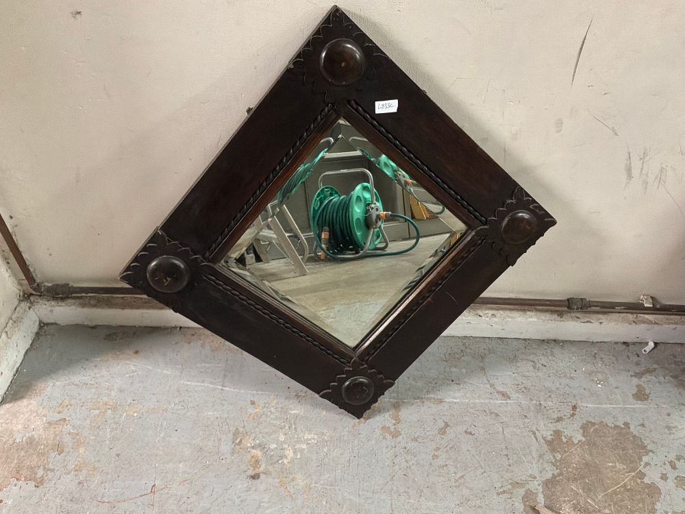 Lot 13: A Late Victorian or Edwardian Bevelled Wall Mirror in a Dark Stained Wooden Frame