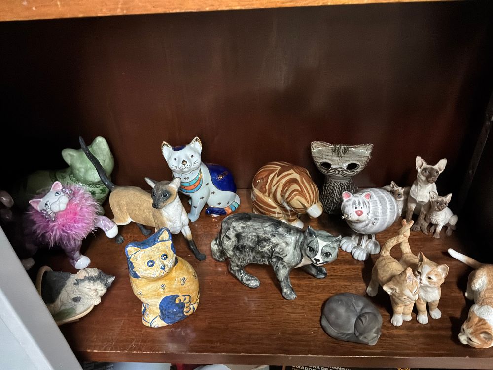 Lot 19: A Collection of Ceramic and Resin Cat Figurines in Various Styles