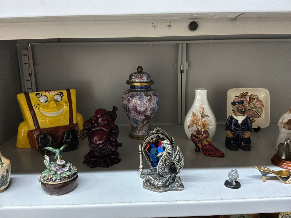 Lot 26: A Collection of Decorative Figurines and Ornaments in Various Styles and Materials