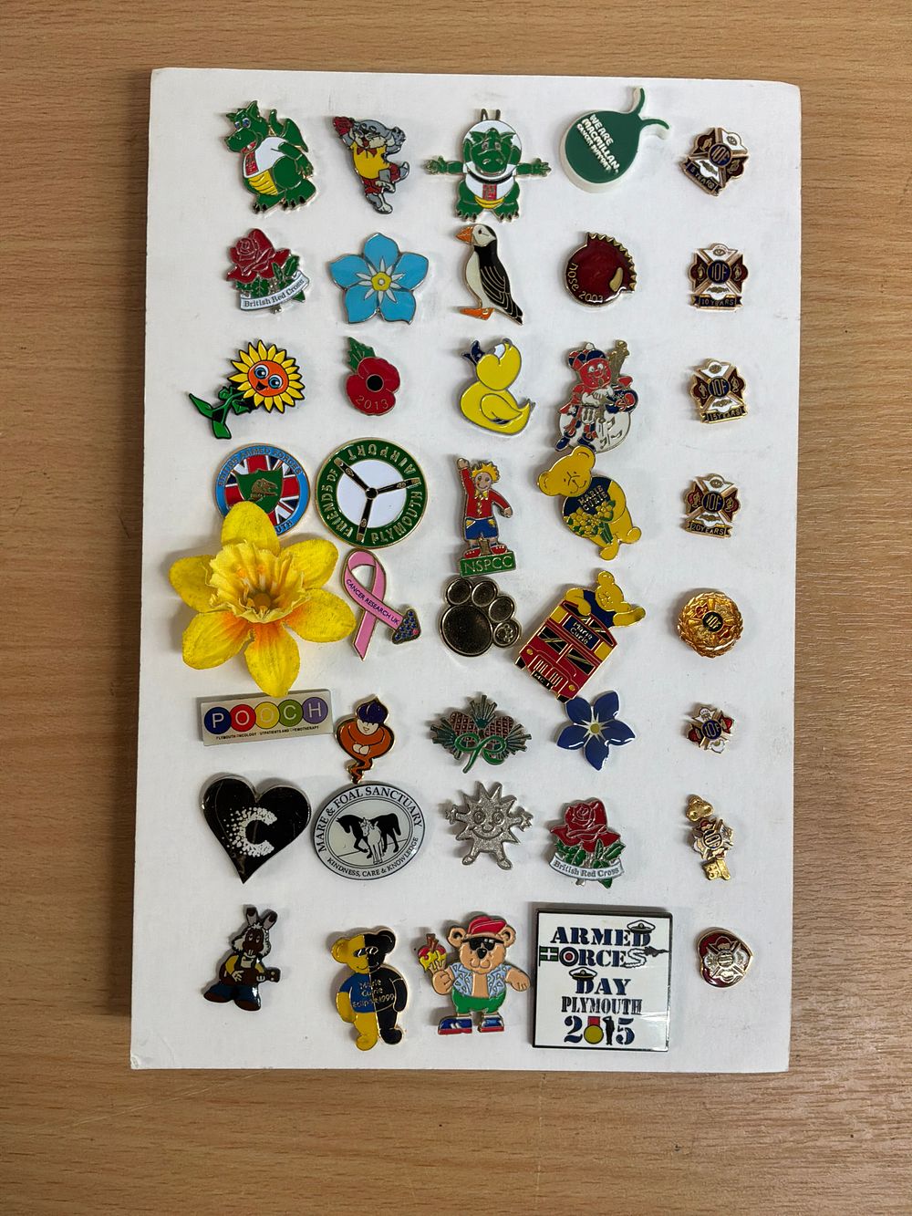 Lot 72: A Collection of Enamel and Metal Pin Badges Including RNLI and Macmillan Examples