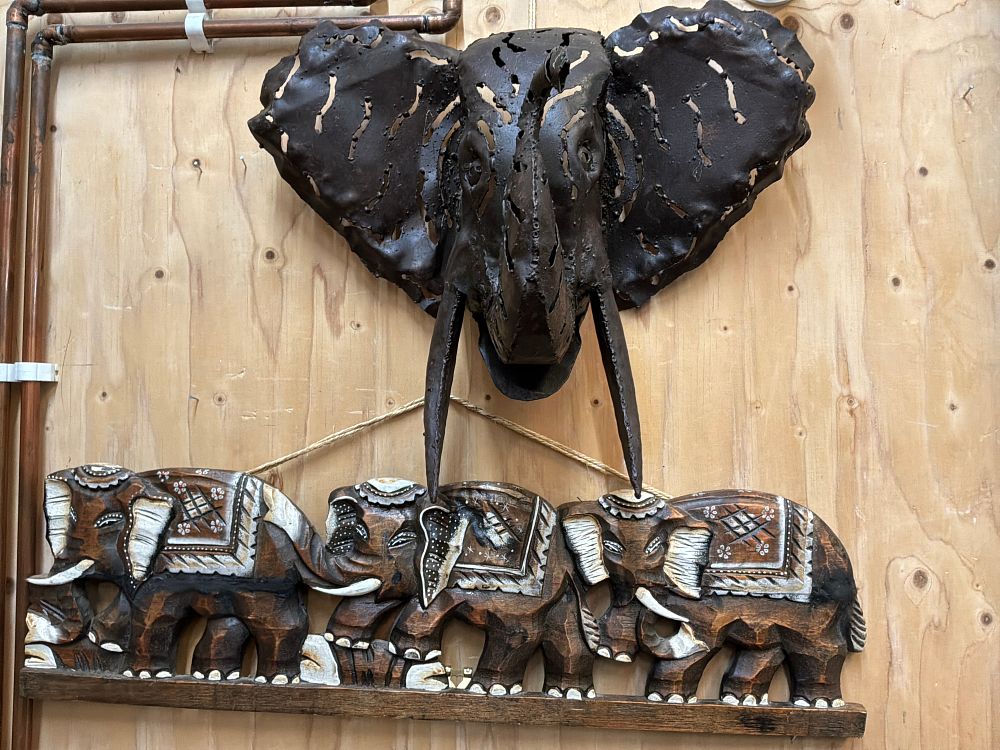 Lot 106: A Two Piece Collection of Elephant Themed Metal and Carved Wooden Wall Decorations