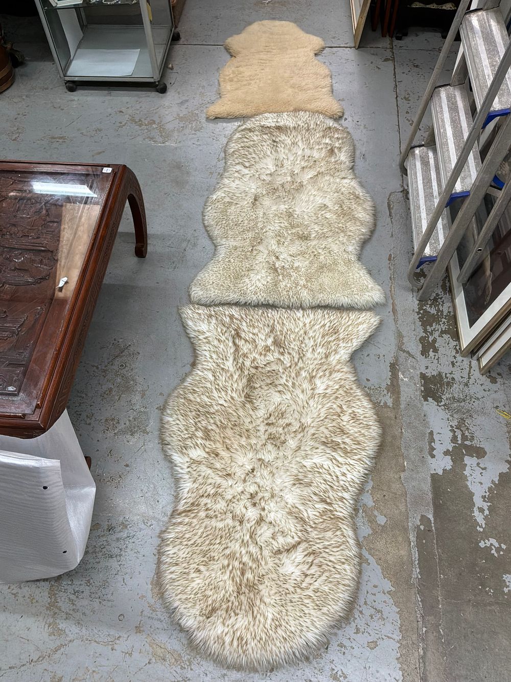 Lot 111: A Trio of Accent Rugs including a Country Life Sheepskin Rug and Two Faux Fur Runners