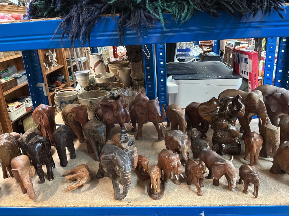 Lot 242: A Collection of Elephant Figurines in Various Styles Including Carved Wood and Stone Examples