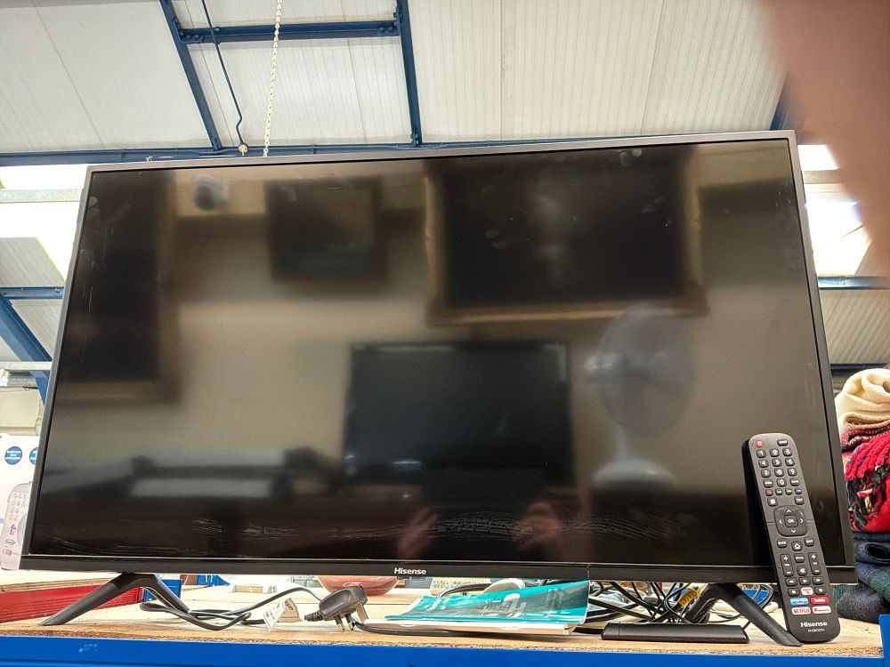 Lot 246: A Hisense Smart Television with Remote Control and Stand
