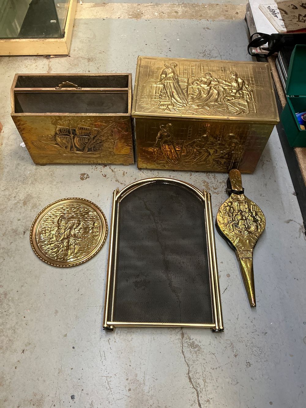 Lot 263: A Collection of Embossed Brass Fireplace Accessories Including Magazine Racks and Bellows