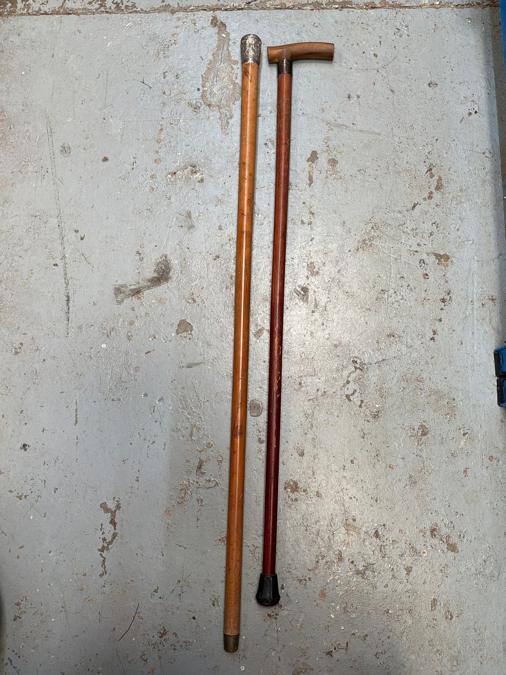 Lot 342: A Pair of Antique Walking Canes with Chased Metal Mounts