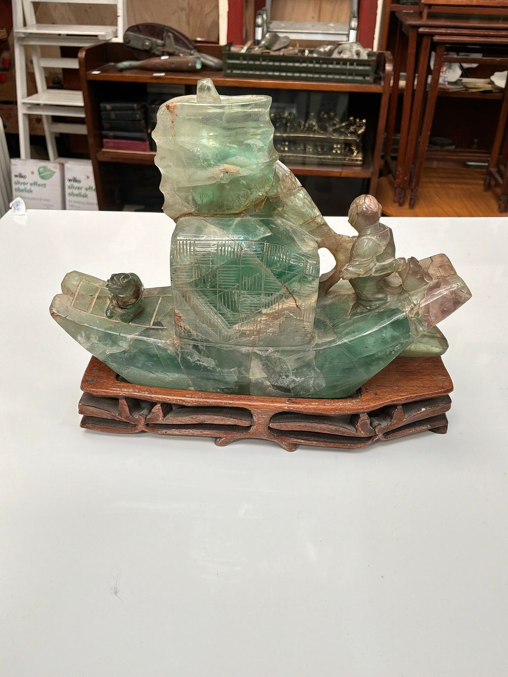 Lot 355: A Chinese Large Carved Green Fluorite Ship Ornament on a Pierced Wooden Base