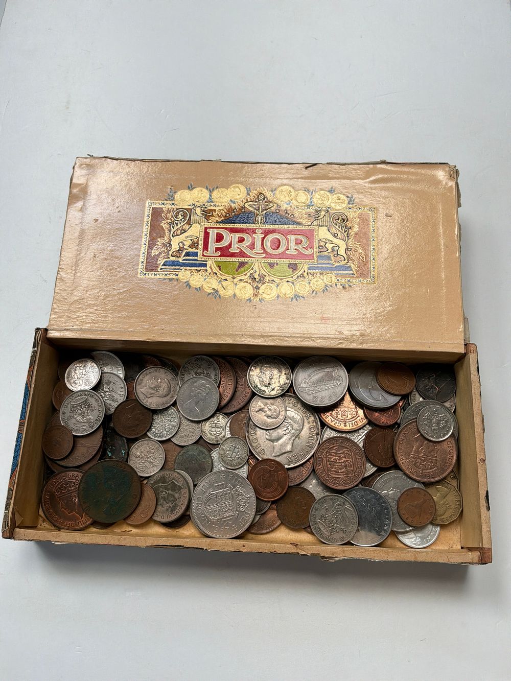 Lot 371: A Collection of Assorted British and Irish Base Metal and Silver Style Coins in Prior Box
