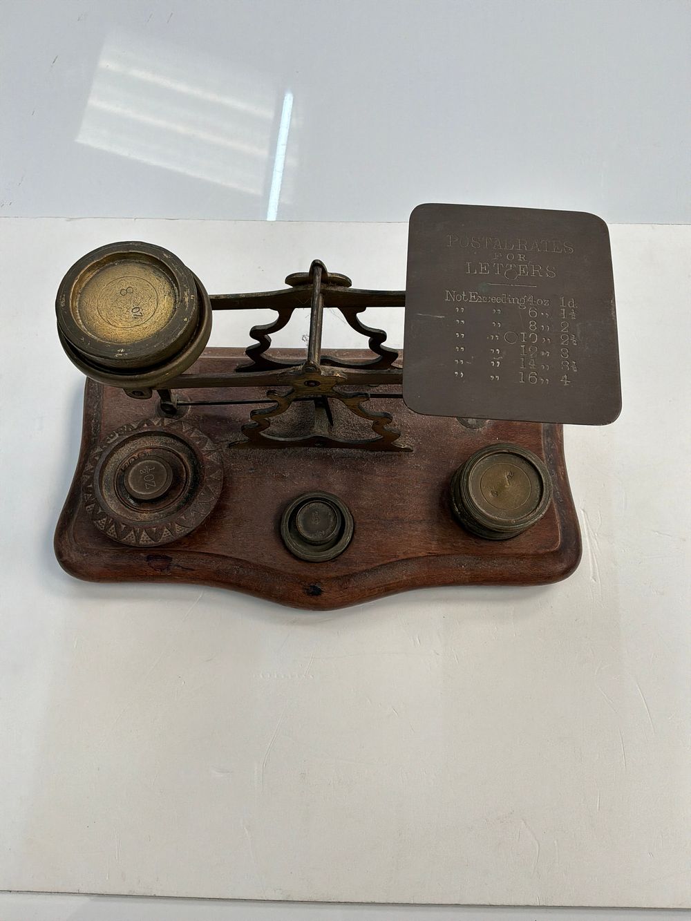 Lot 385: A Victorian Brass and Mahogany Beam Postal Scale with a Set of Five Graduated Weights