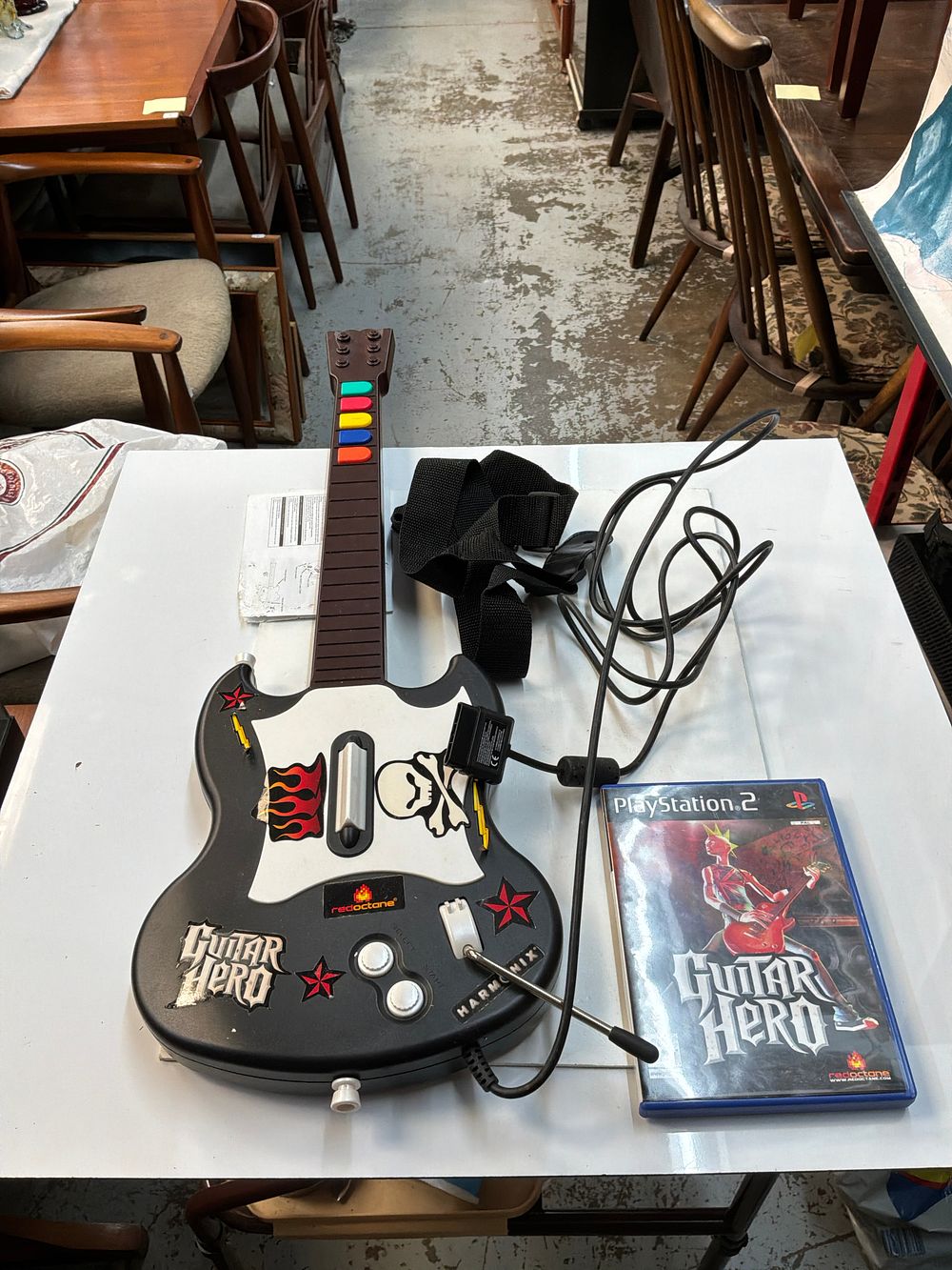 Lot 407: A Sony PlayStation 2 Guitar Hero Controller with Game and Strap