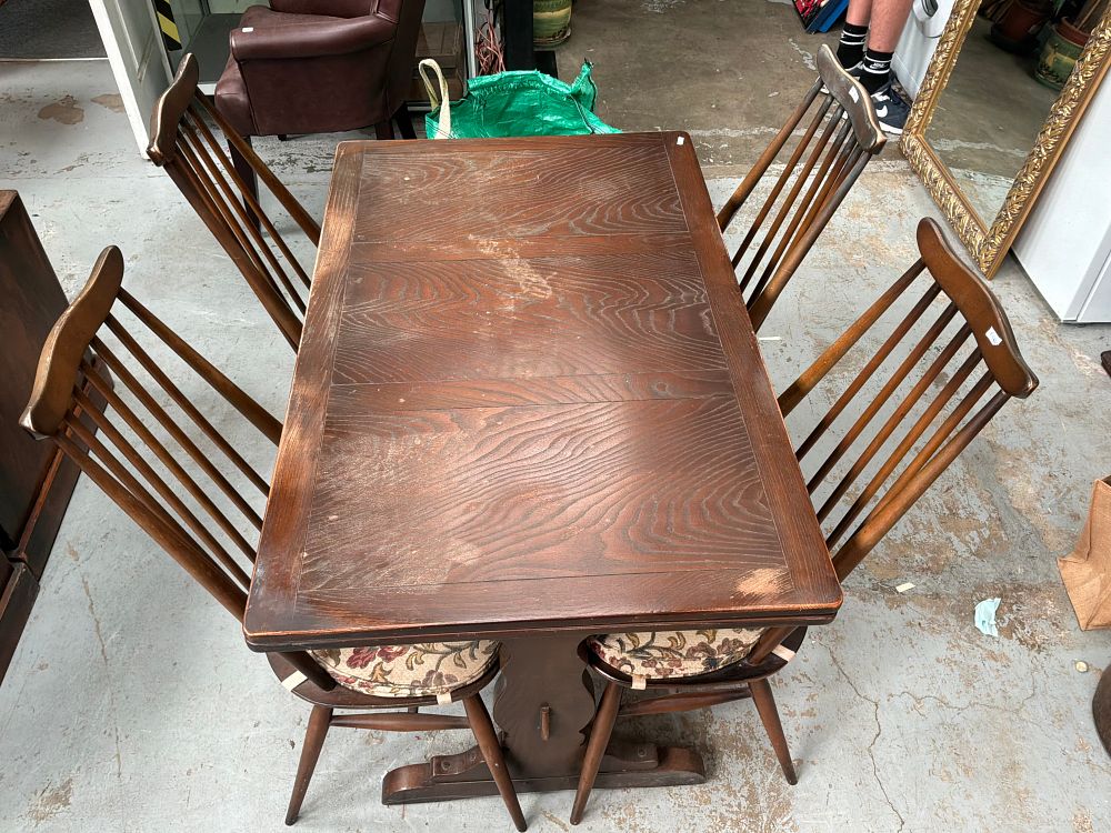 Lot 443: A Mid-Century Modern Oak Extension Trestle Dining Table and a Set of Four Spindle Back Chairs