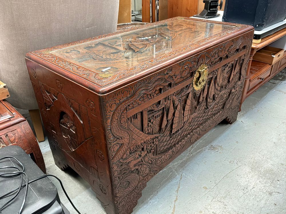 Lot 453: A Mid-20th Century Carved Camphor Wood Blanket Chest with Glass Top