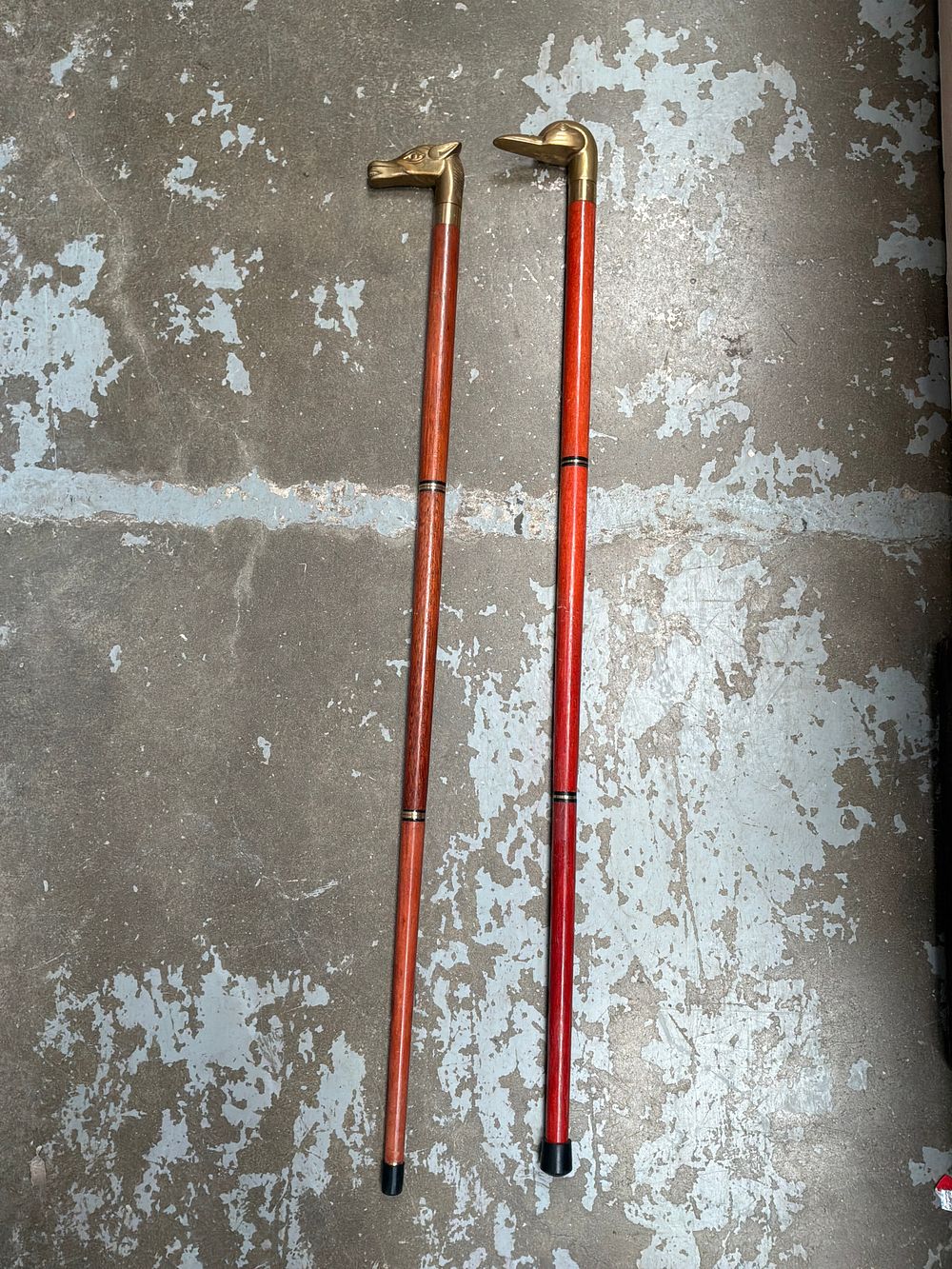 Lot 457: A Pair of Stylised Brass and Stained Hardwood Animal Form Sectional Walking Sticks