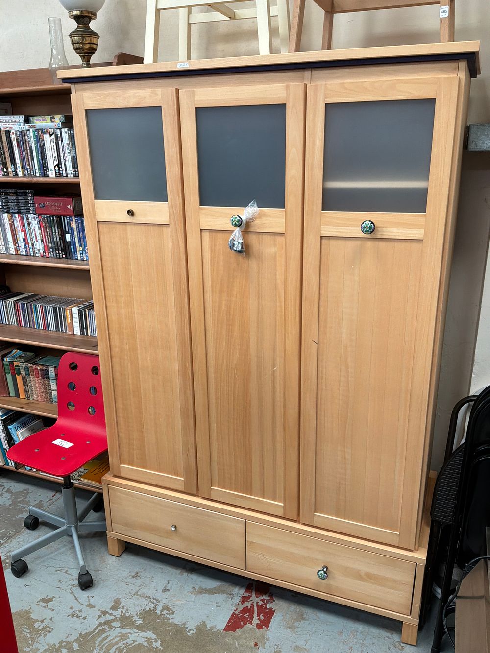 Lot 486: A Contemporary Light Wood Three Door Wardrobe with Two Drawers and Frosted Glass Panels