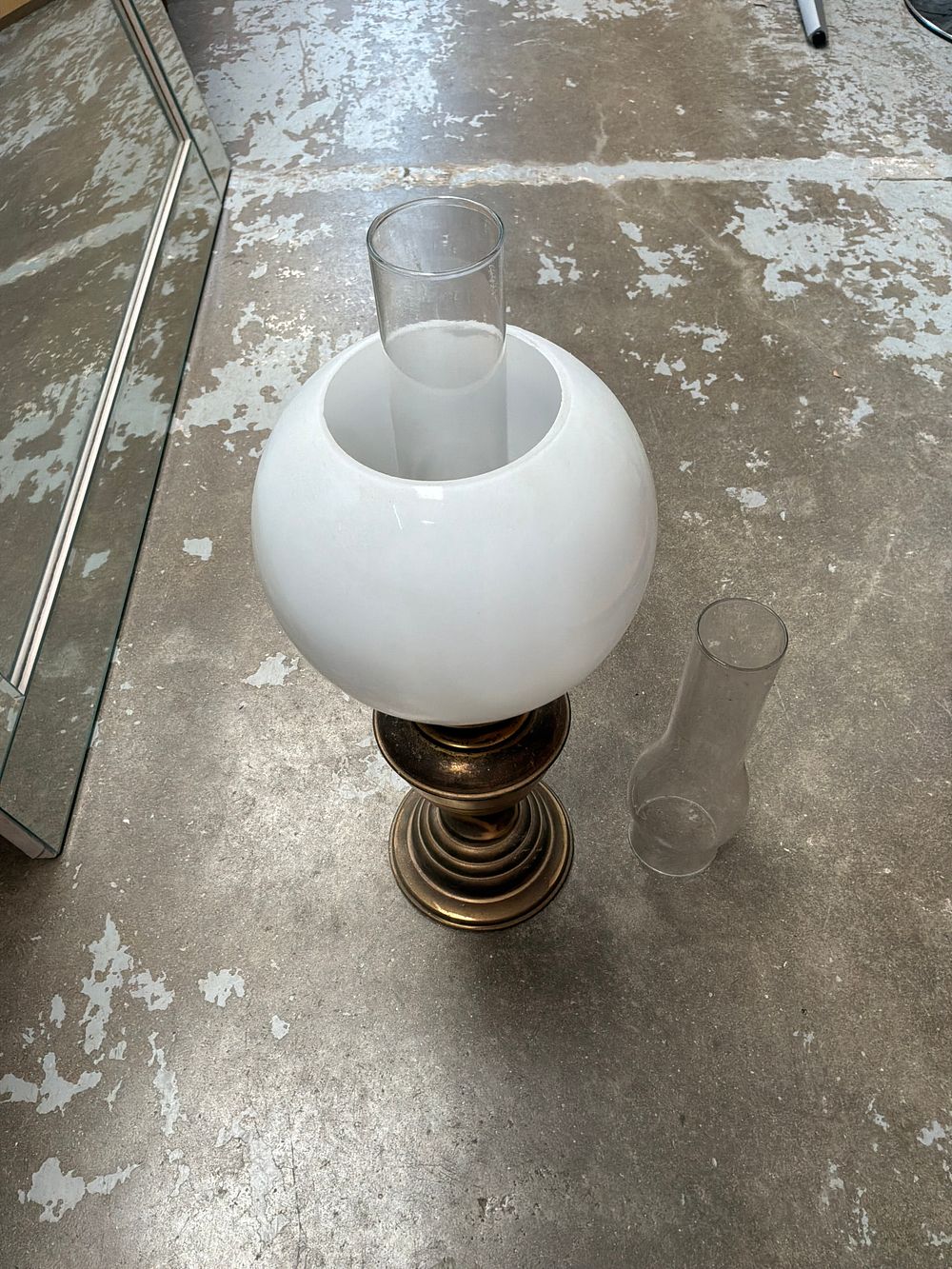 Lot 487: A Brass style Hurricane Table Lamp with Milk Glass Shade and Two Chimneys