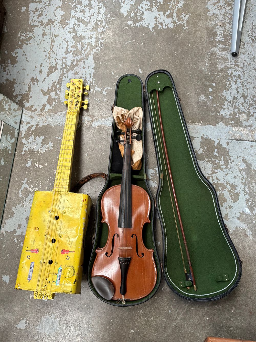 Lot 492: A Violin in Cares and a Handcrafted Six-String Folk Art Tin Guitar