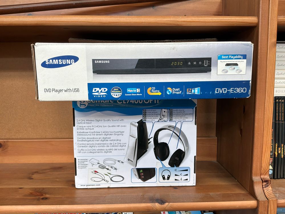 Lot 494: A Group of Two Consumer Electronics Comprising a Samsung DVD Player and a Geemarc Wireless Headphone System in Retail Packaging