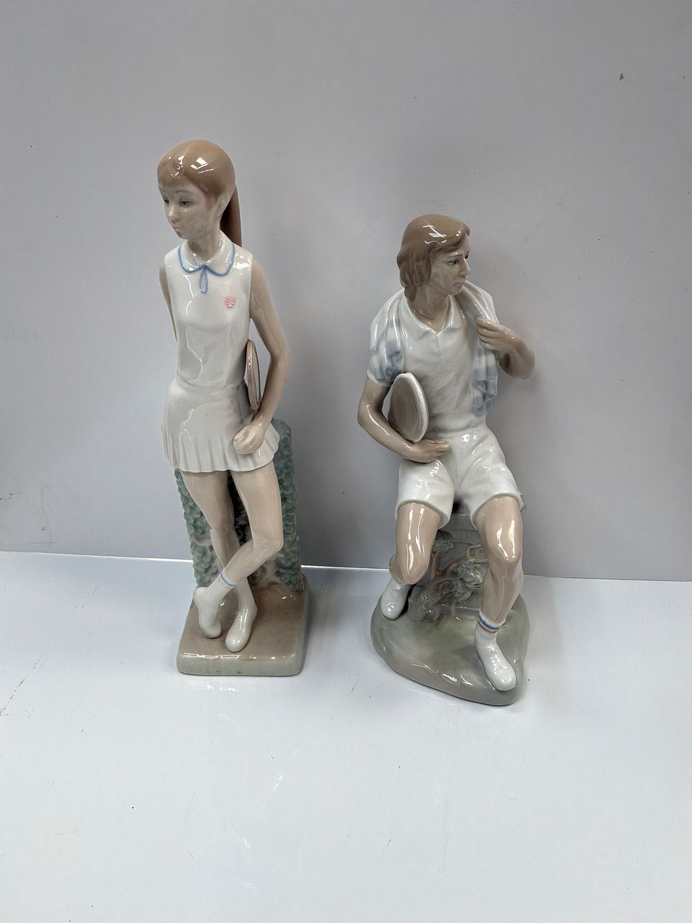 Lot 497: A Pair of Glazed Porcelain Figurines Depicting Tennis Players by Lladro