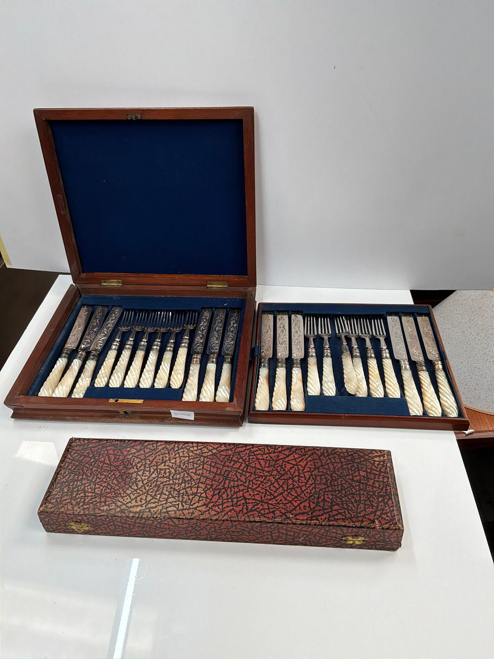 Lot 512: A Set of Twenty Four Late Victorian style Dessert Knives and Forks and a Cased Two Piece Carving Set