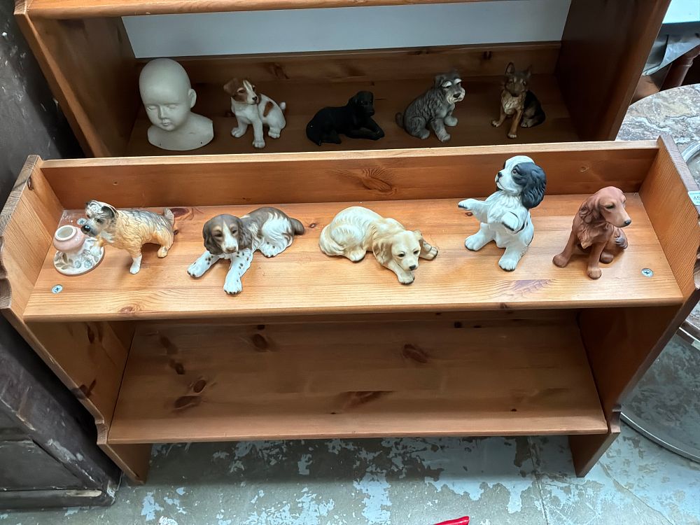 Lot 513: A Collection of Ceramic Canine Figurines and a Bisque Porcelain Doll Head
