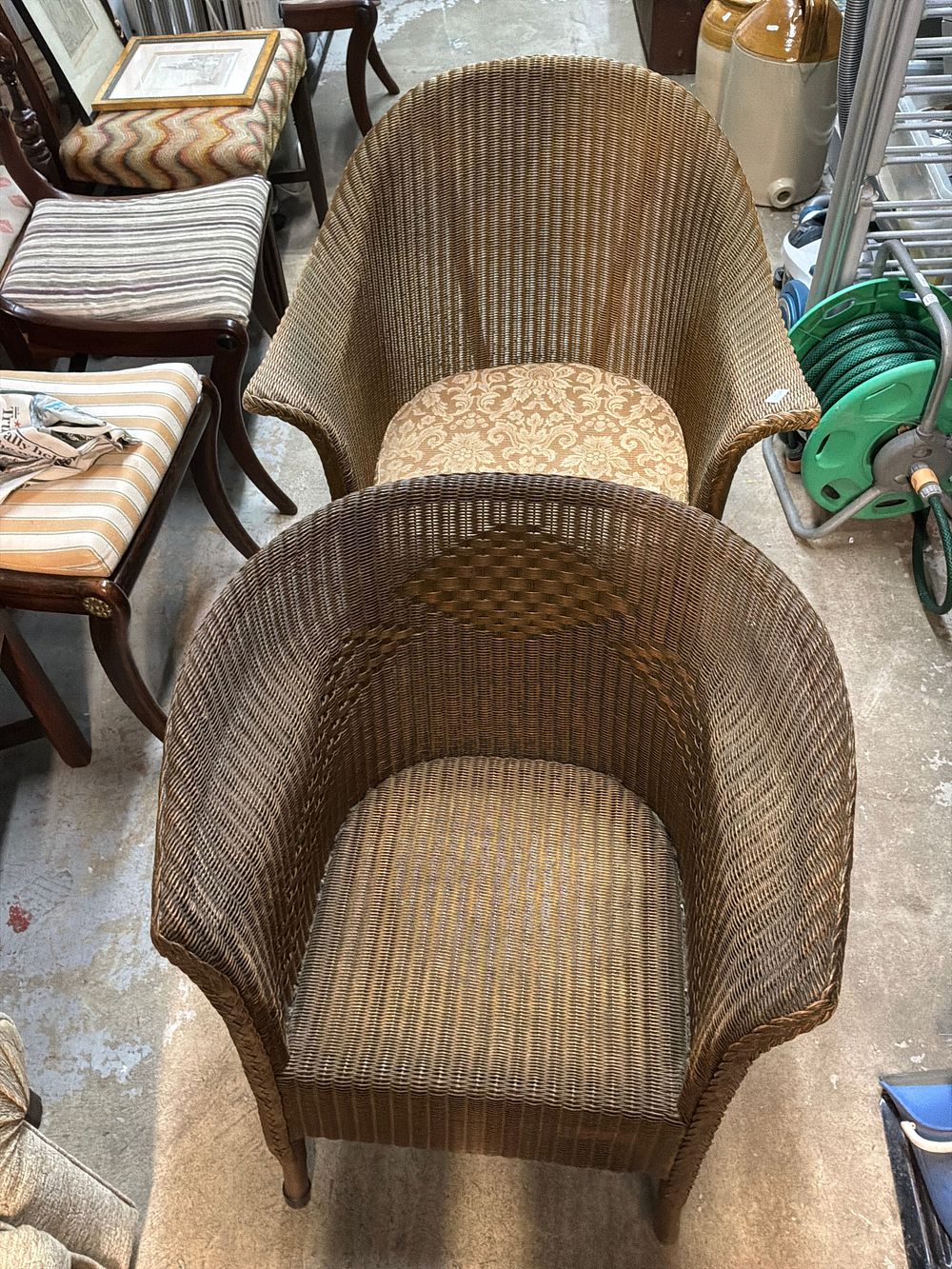 Lot 546: A Pair of Lloyd Loom Style Metallic Finished Wicker Armchairs
