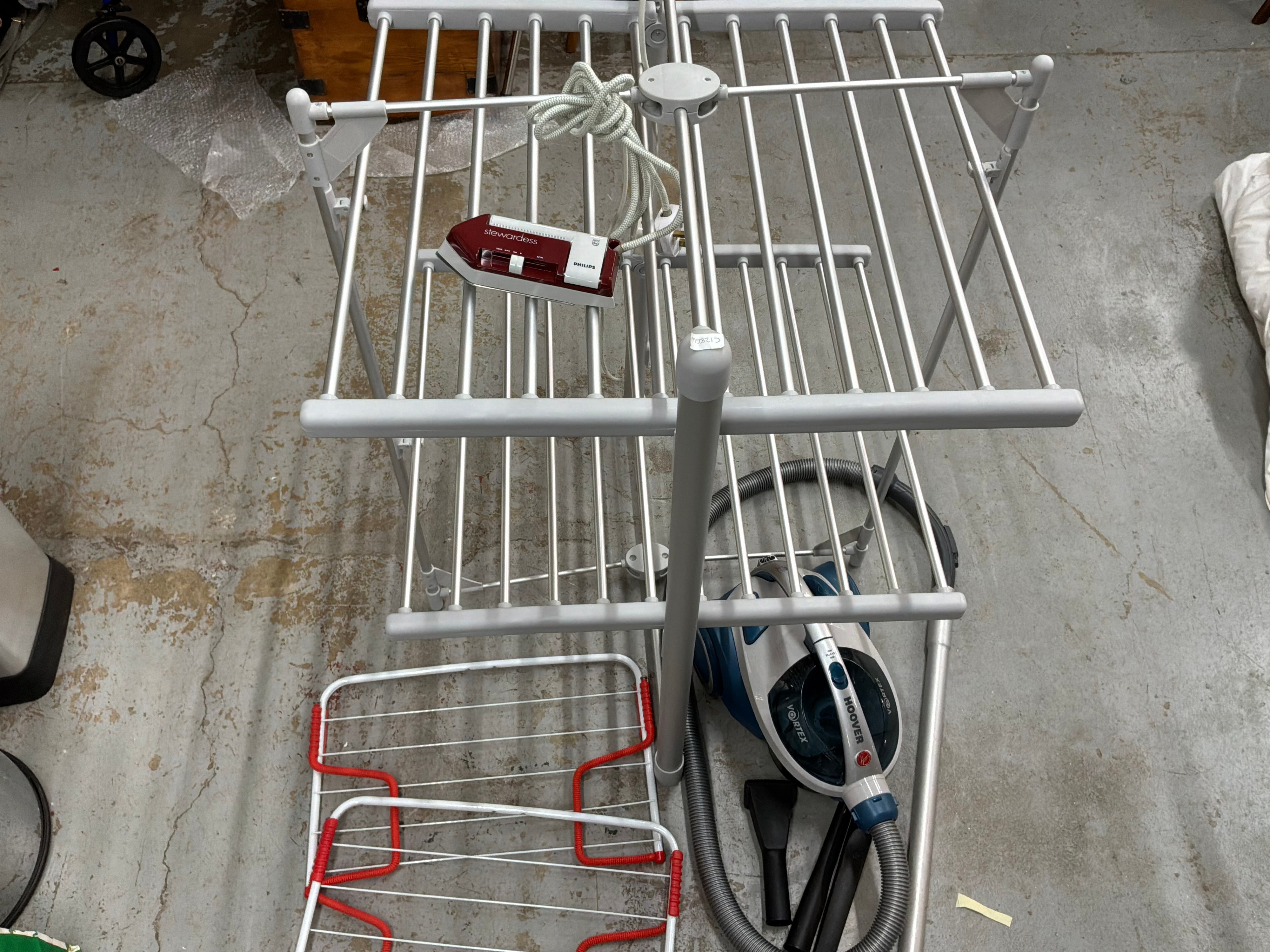 A Group of Household Appliances Including a Hoover Vacuum Cleaner and a Heated Tower Airer