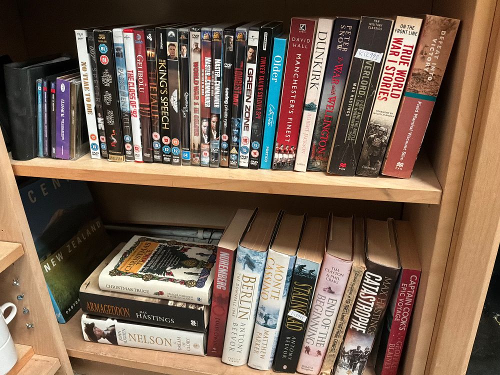 Lot 168: A Collection of Military History and Biography Books and DVDs including Penguin and Viking Examples