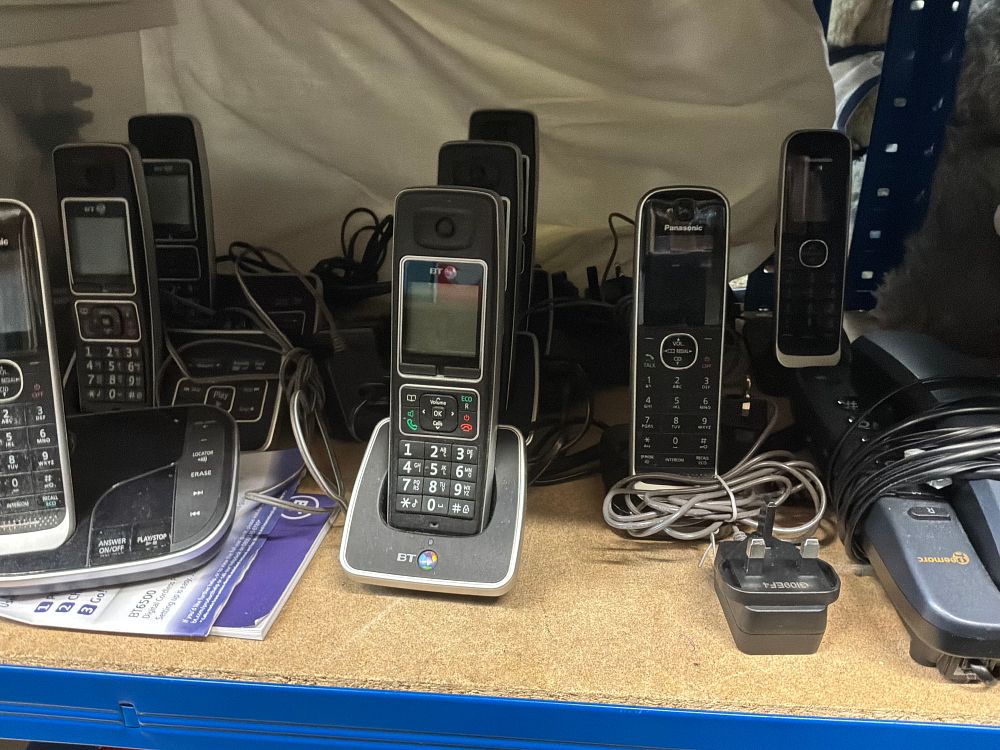 Lot 186: A Collection of Cordless Telephones and Electrical Accessories Including BT and Panasonic Examples