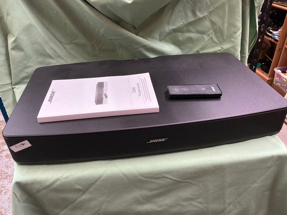 Lot 222: A Bose Solo TV Sound System with Remote Control and Owner's Guide