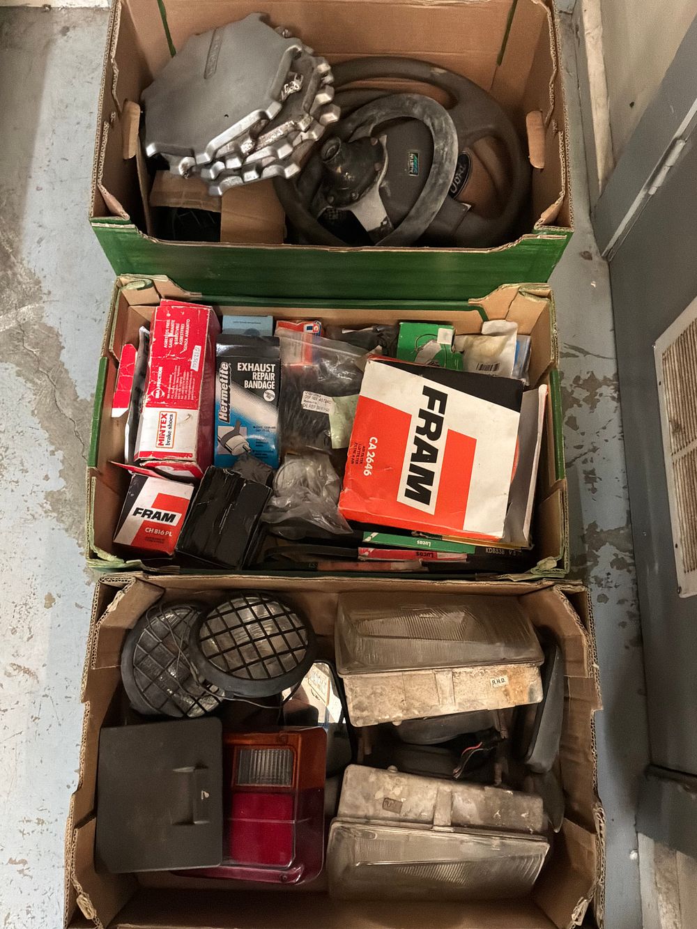 Lot 249: An Assortment of New Old Stock and Used Automotive Parts Including Fram and Austin Examples