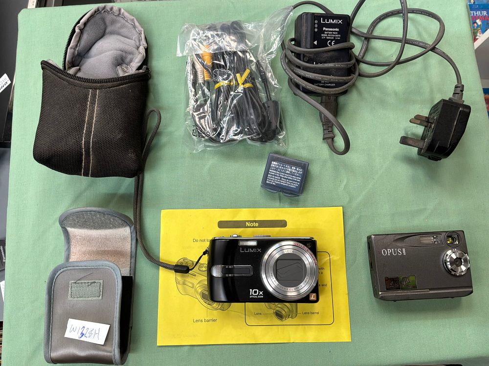Lot 260: A Group of Two Digital Compact Cameras and Accessories including Panasonic and Opus Examples