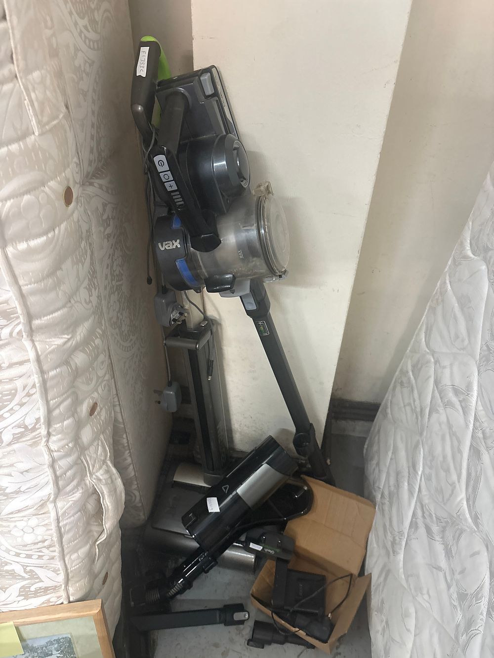 Lot 384: A Group of Three Cordless Vacuum Cleaners Including Vax and Gtech Examples