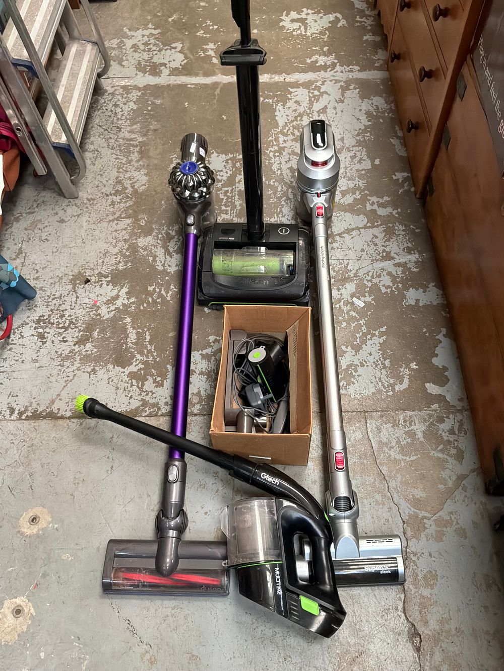 Lot 414: A Collection of Four Cordless Vacuum Cleaners including Dyson and Gtech Examples