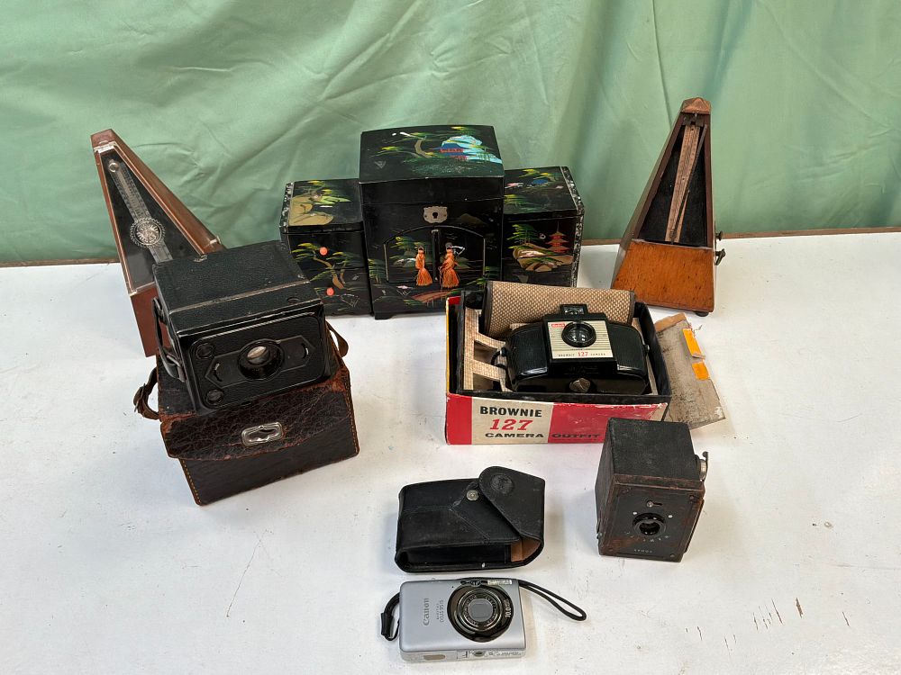 Lot 7: A Collection of Vintage Cameras, Metronomes, and a Japanese Style Musical Jewellery Box