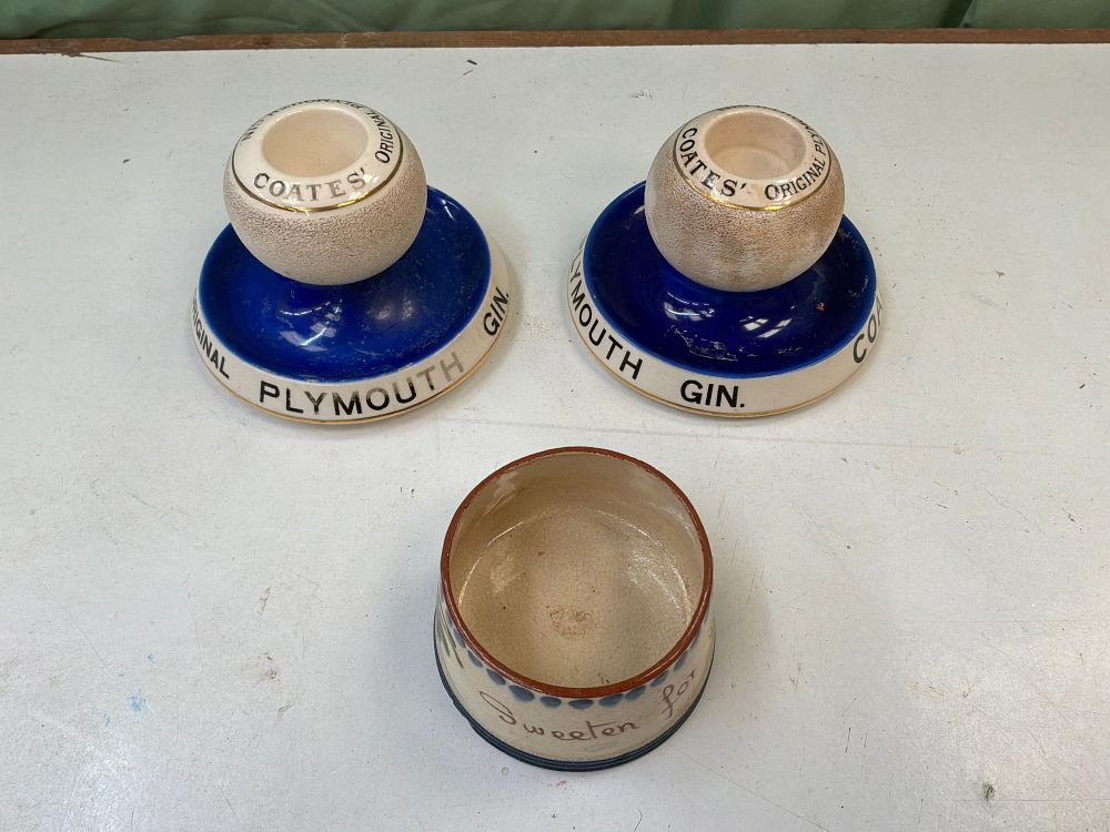 Lot 45: A Pair of Shelley Ceramic Match Strikers for Coates' Plymouth Gin and a Watcombe Pottery Preserve Pot